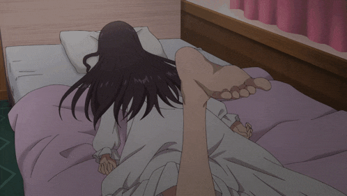 a woman is laying on a bed with a pink curtain behind her