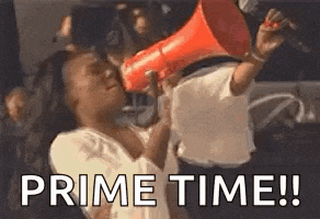 a woman is holding a megaphone in front of her face and screaming .