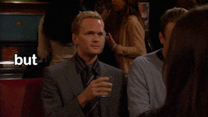 a man in a suit and tie is holding a drink and says but you know ... don 't
