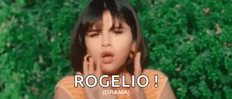 a close up of a woman blowing a kiss with the words rogelio written on the bottom .