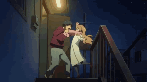 a man and a woman are fighting on stairs at night