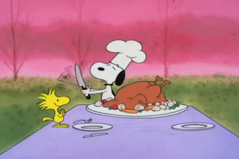 snoopy is holding a knife in front of a turkey