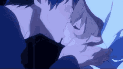 a man and a woman are kissing in a blue room