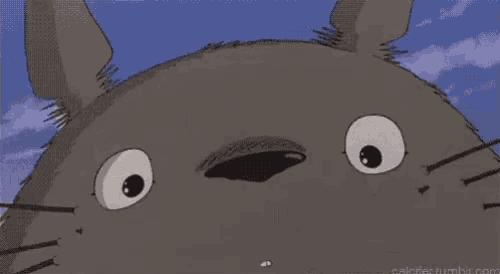 a close up of a totoro from my neighbor totoro with a big smile on his face .
