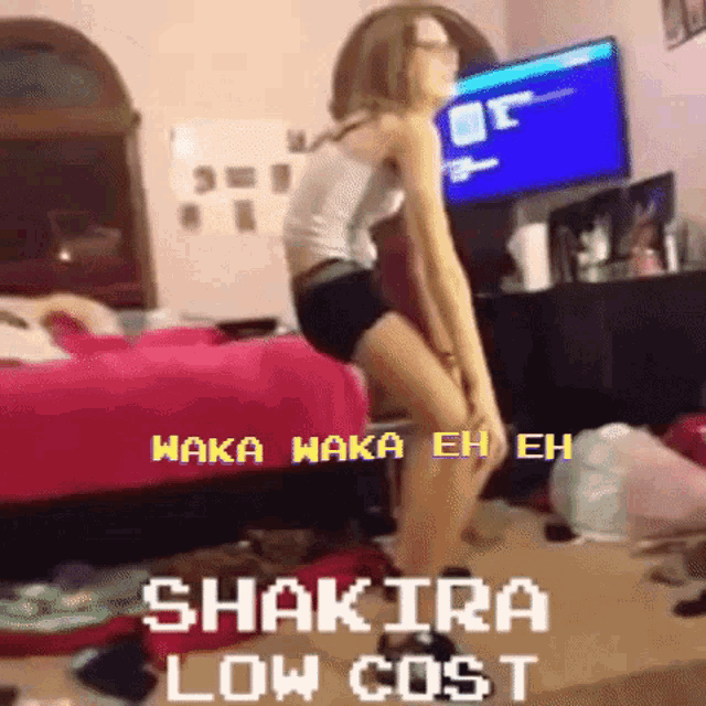 a woman is dancing in front of a tv with the words shakira low cost
