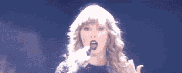 a close up of a woman singing into a microphone .