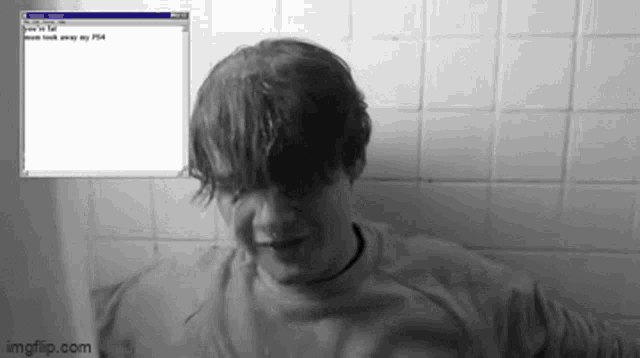 a black and white photo of a man in a bathtub with a notepad window behind him