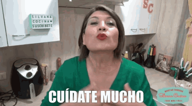 a woman says " cuidate mucho " in a kitchen