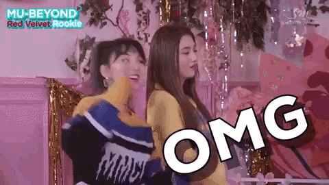 two women are standing next to each other with the word omg written on the screen .