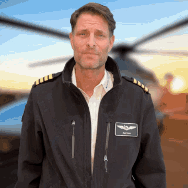 a man wearing a jacket with a patch on it that says ' tom thomas '