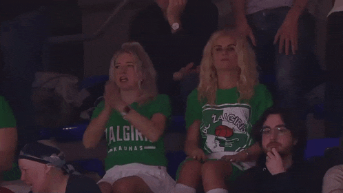 a woman wearing a green shirt that says " algiris " on it