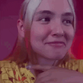 a close up of a person 's face with a pink and purple background