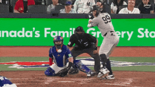 a baseball player with the number 99 on his jersey swings at a ball