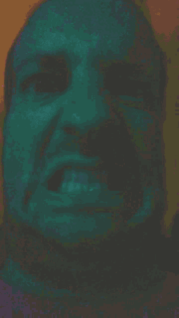 a close up of a man 's face with his mouth open
