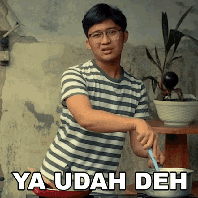a man in a striped shirt is cooking with the words ya udah deh written on the bottom