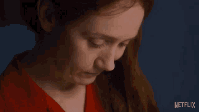 a close up of a woman 's face with netflix written on the bottom right