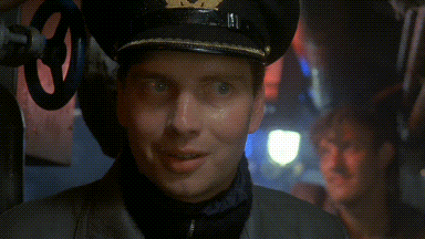 a man in a military uniform with a hat that has a circle on it