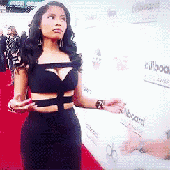 a woman is standing on a red carpet in front of a wall that has the word billboard on it