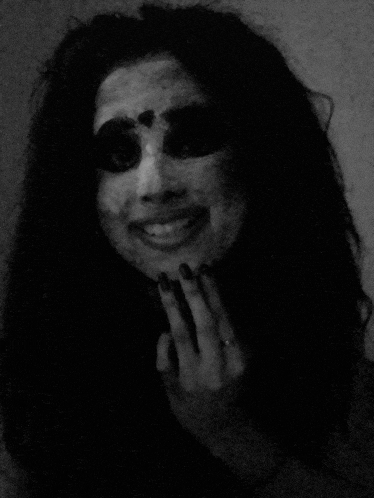 a black and white photo of a woman 's face with a ring on her finger