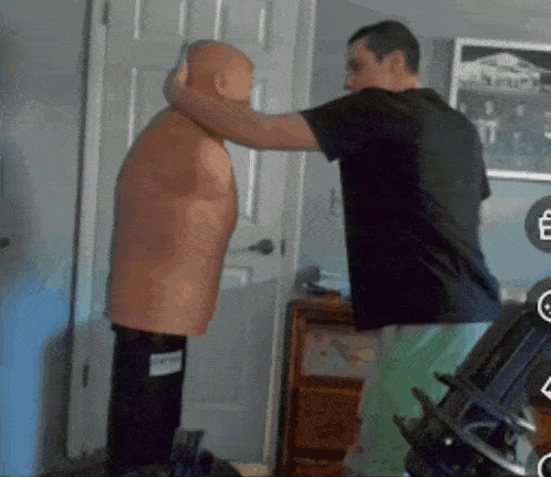 a man in a black shirt is standing next to a punching bag with a label on it that says ' smith '