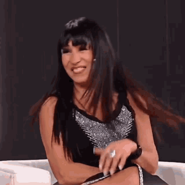 a woman with a ring on her finger is smiling and laughing