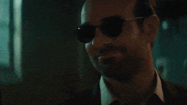 a man wearing sunglasses and a suit says " i like it "