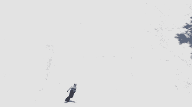a snowboarder is doing a trick on top of a snow block that has the letter m written on it