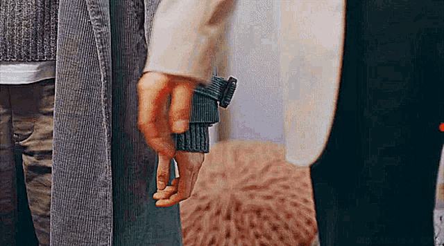 a man and woman are holding hands in a room .