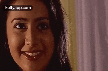a close up of a woman 's face with a smile .