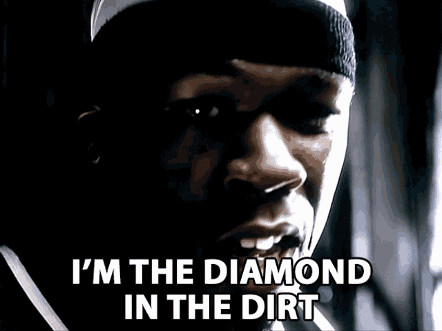 a close up of a man 's face with the words i 'm the diamond in the dirt