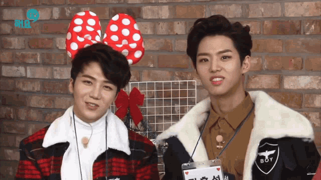 two young men are standing next to each other with one wearing a name tag that says boy