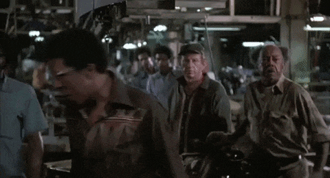 a group of people are gathered in a room and the words blue collar are visible