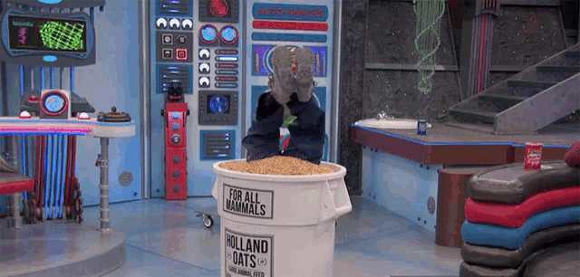 a person is standing in a bucket that says holland oats on it