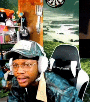 a man wearing a hat and headphones sits in a chair that says gtplayer