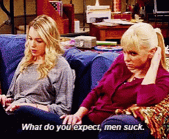 two women are sitting on a couch and one of them says what do you expect men suck