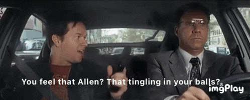 a man in a suit and tie is talking to another man in a car and the words " you feel that allen " are visible