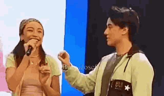 a man and a woman are standing next to each other .