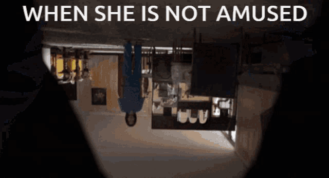 a woman is upside down in a room with the words " when she is not amused " on the bottom