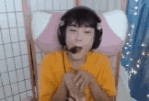 a person wearing headphones and a microphone is sitting in a chair