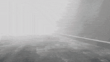 a black and white photo of a foggy road