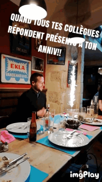 a man sitting at a table with a sign that says ekla vandenhevel