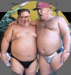 two fat men in underwear are standing next to each other and laughing .