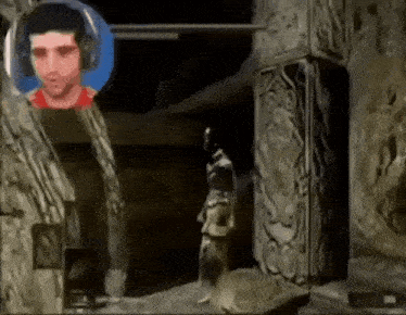 a man wearing headphones is standing next to a statue in a cave .