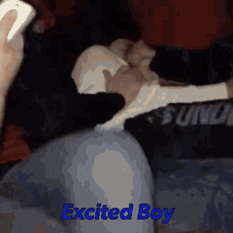 a person is laying on a couch with the words excited boy on the bottom