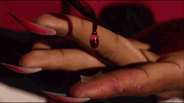 a close up of a person 's hand with blood dripping from it