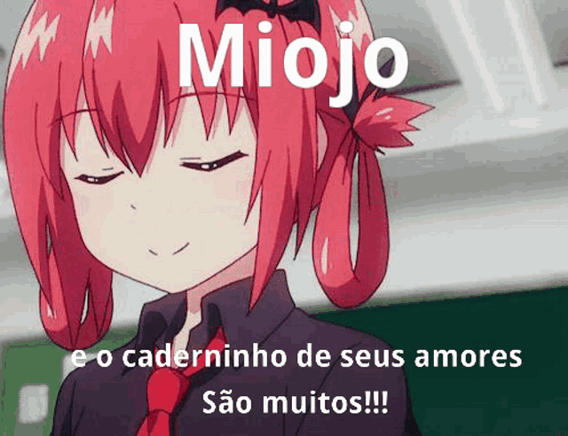 a girl with red hair is wearing a black shirt and a red tie and has the word miojo on her head .