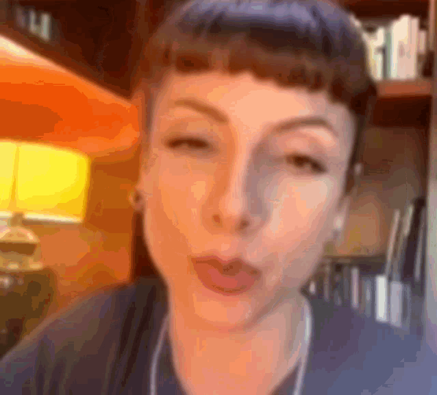 a close up of a woman 's face with a blurred background