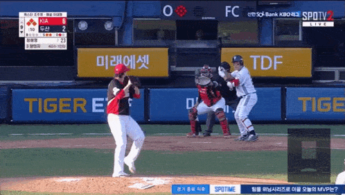 a baseball game is being played in front of a sign that says tiger on it