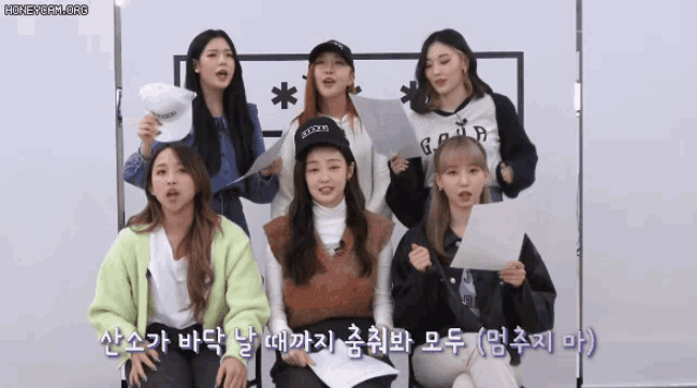 a group of girls are singing in korean