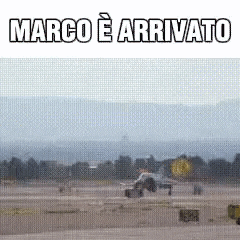 a picture of a plane on a runway with the words marco e arrivato written on it .